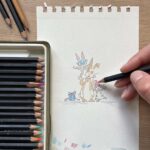 An artist drawing a children's birthday card
