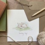 A sending hugs greeting card with a cat design