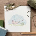 A greeting card with a cute piglet illustration