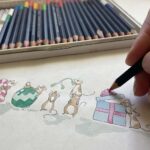 An artist drawing an illustrated Christmas card