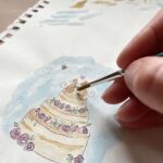 An artist painting a wedding card