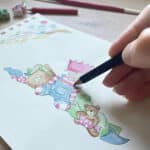 An artist drawing a children's Christmas card