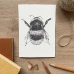 A greeting card with a bee illustration