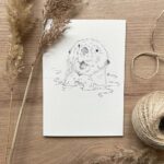 A notecard with an otter design