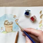 An artist illustrating a watercolour hedgehog