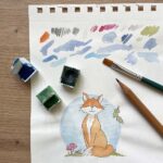 An artist illustrating a woodland scene with a fox