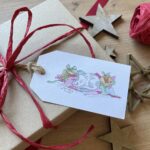 A Christmas present wrapped with a cat design gift tag