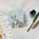 An artist illustrating a watercolour badger