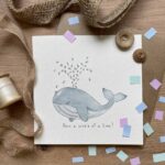 A sea animal greetings card with a blue whale spraying congratulations confetti from his spout