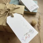 A set of recycled gift tags featuring a cute brown and white mouse