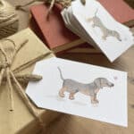 A set of recycled gift tags featuring a cute sausage dog