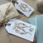 A set of recycled birthday gift tags featuring otterly adorable little otters