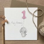 A 1st birthday greetings card with an elephant holding a balloon