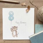 A 8th birthday card for children featuring a meerkat with a balloon