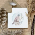 An art greetings card of a bird of prey showing a kestrel sitting on a post