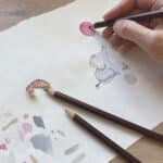 An artist illustrating a birthday card with an adorable elephant