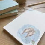 A lined notepad with otter illustration