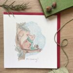 A Christmas card with a cute red squirrel in the snow