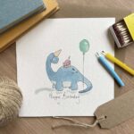 A dinosaur birthday card with a diplodocus