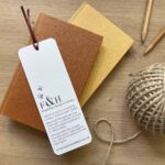 A recycled paper bookmark with dog design