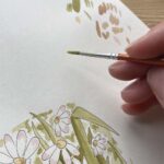 An artist creating a watercolour card