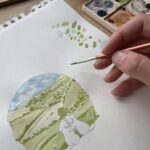 An artist painting a watercolour card